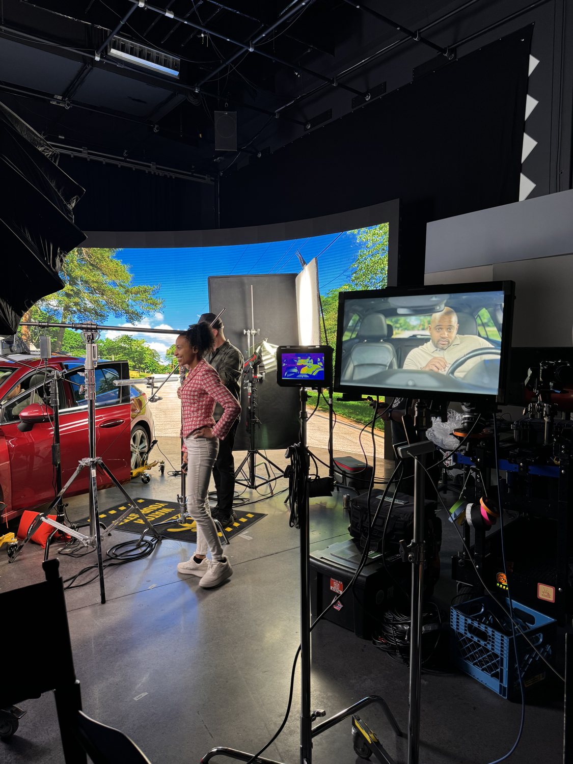 Chelsea watching an actor she coached through the monitors on a commercial set